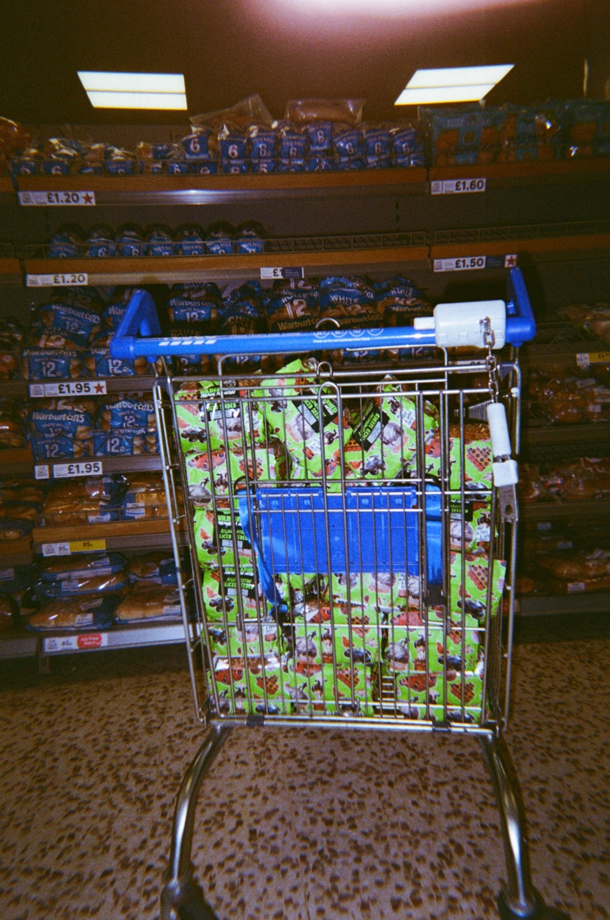 Tesco trolley filled with Wildfarmed bread in the bread aisle